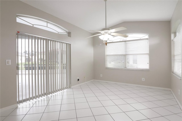 tiled empty room with ceiling fan, vaulted ceiling, and a wealth of natural light