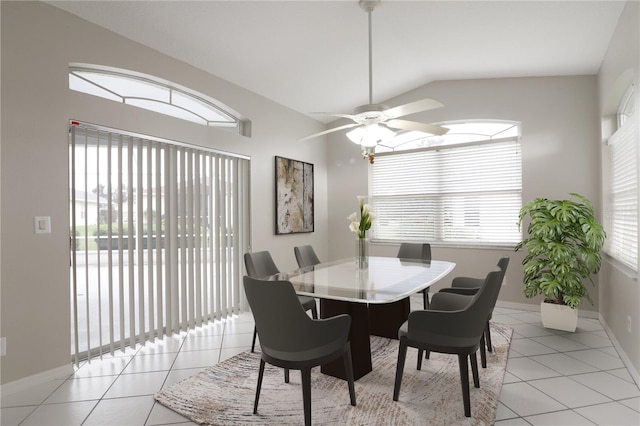 dining space featuring ceiling fan, vaulted ceiling, and light tile patterned floors