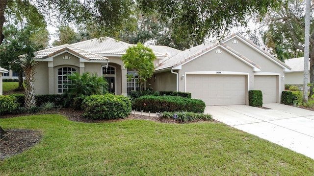 ranch-style home featuring a garage and a front yard