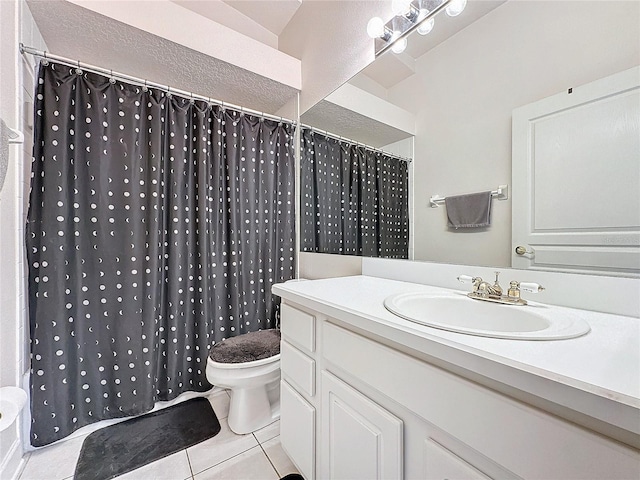 bathroom featuring tile patterned flooring, sink, and toilet