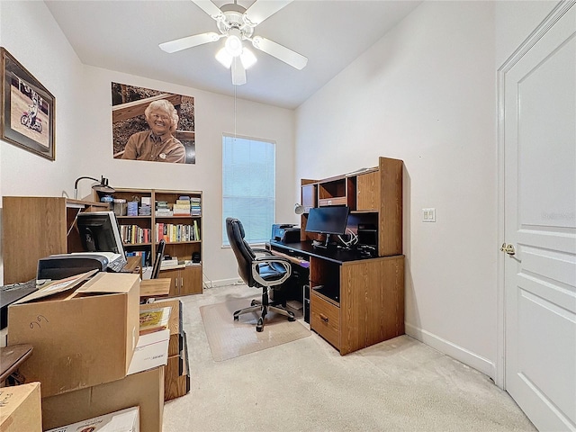 carpeted office featuring ceiling fan