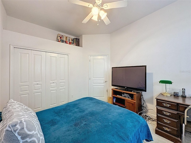 carpeted bedroom featuring a closet and ceiling fan