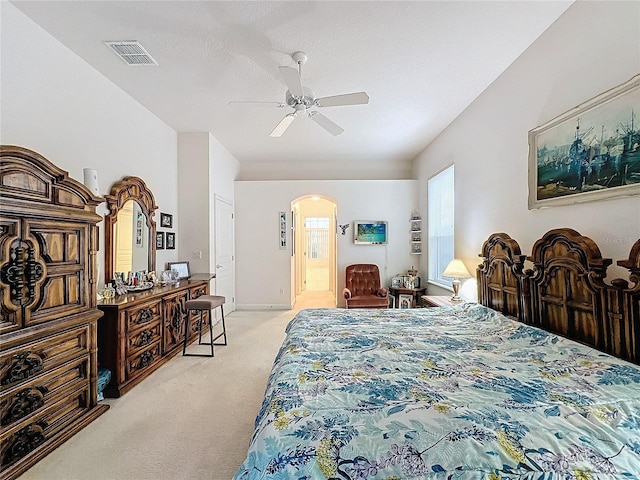 carpeted bedroom with ensuite bathroom, ceiling fan, and a textured ceiling