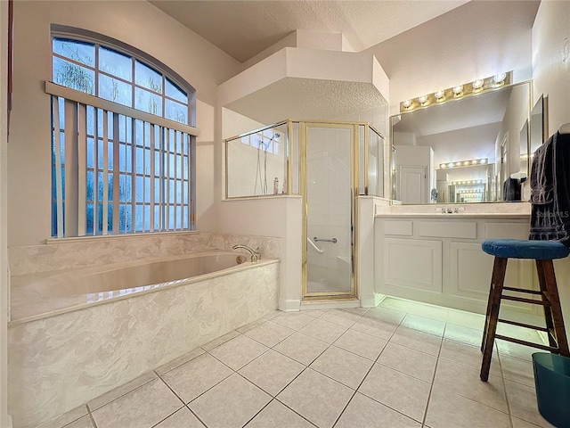 bathroom with tile patterned flooring, vanity, a textured ceiling, and independent shower and bath