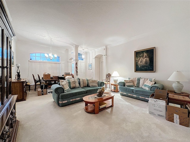 carpeted living room featuring a textured ceiling, a notable chandelier, and ornamental molding