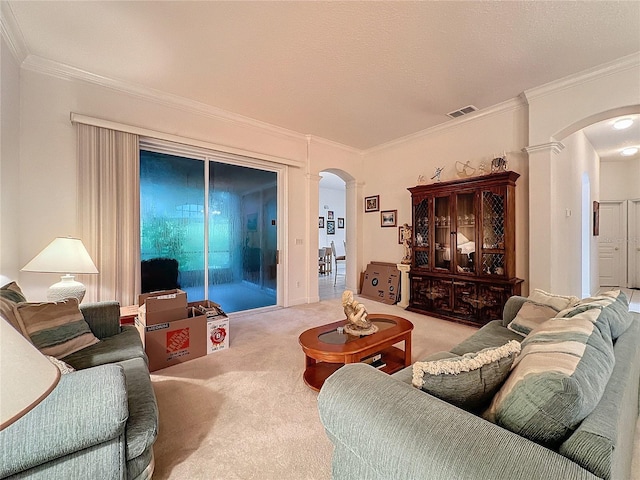 living room featuring decorative columns, a textured ceiling, light carpet, and ornamental molding