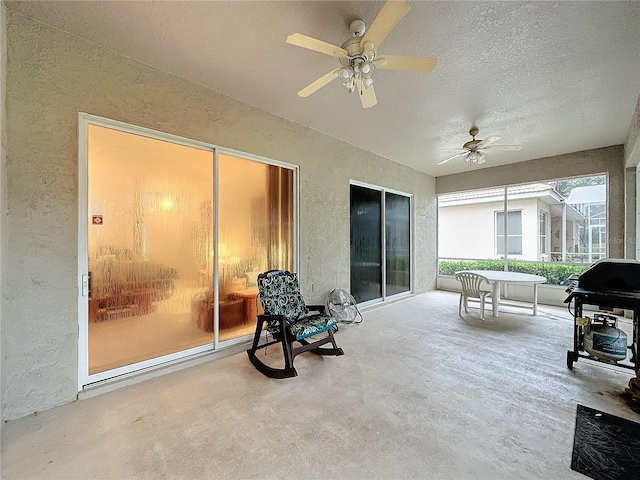 sunroom / solarium featuring ceiling fan