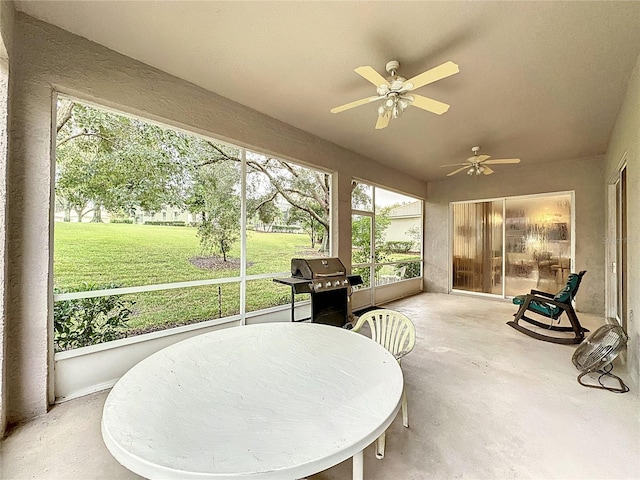 sunroom / solarium featuring ceiling fan and a healthy amount of sunlight