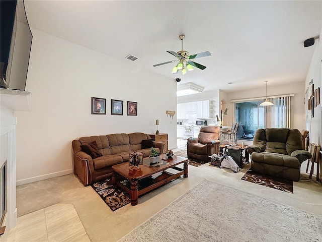 carpeted living room featuring ceiling fan