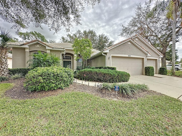 single story home featuring a garage and a front yard