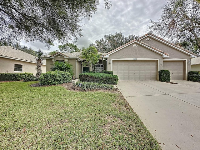 ranch-style home featuring a garage and a front yard