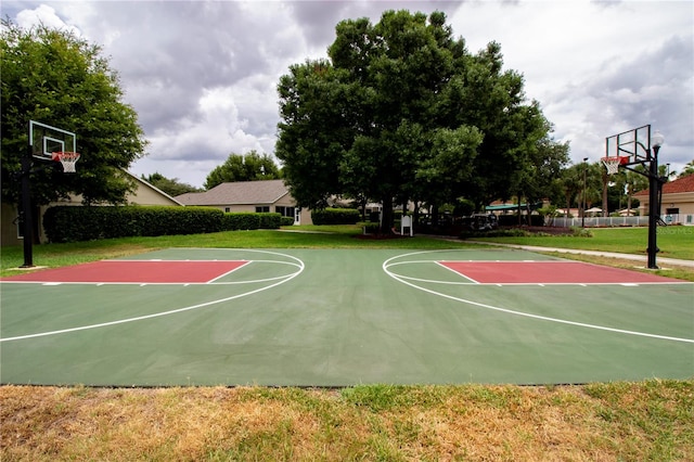 view of basketball court with a yard