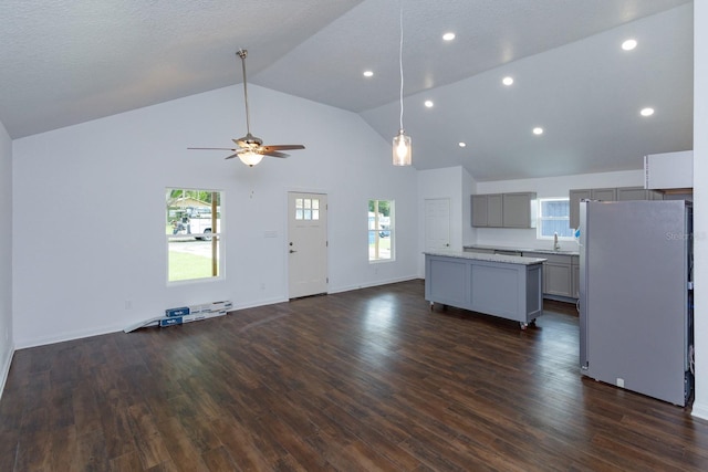 kitchen with gray cabinets, white refrigerator, dark wood-type flooring, and ceiling fan