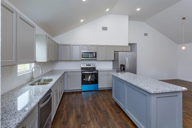 kitchen featuring gray cabinetry, decorative light fixtures, appliances with stainless steel finishes, dark wood-type flooring, and sink