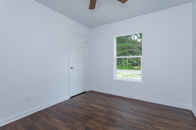 empty room with dark wood-type flooring and ceiling fan