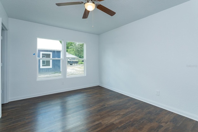 empty room featuring ceiling fan, dark hardwood / wood-style flooring, and a textured ceiling