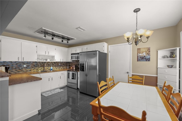 kitchen featuring hanging light fixtures, stainless steel appliances, sink, a chandelier, and white cabinets