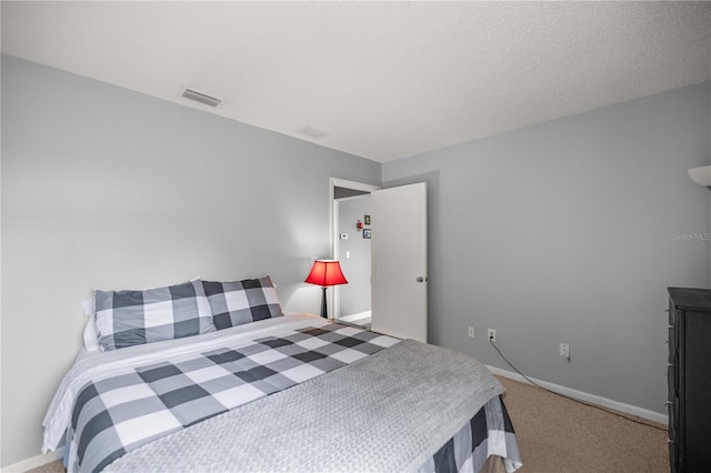 carpeted bedroom with a textured ceiling