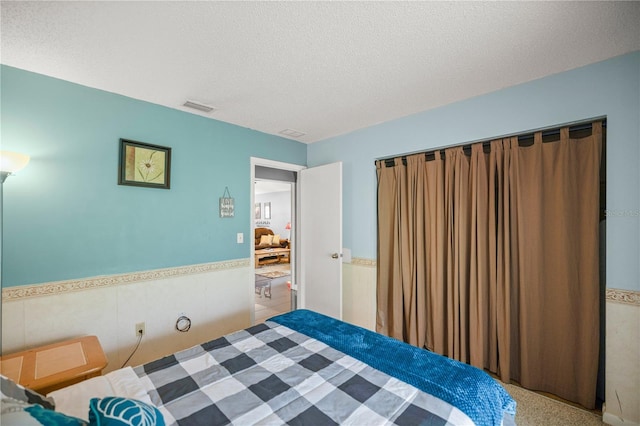 carpeted bedroom featuring a textured ceiling