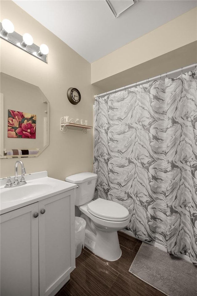 bathroom with vanity, toilet, wood-type flooring, and walk in shower