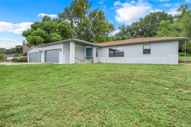 single story home featuring a front lawn and a garage