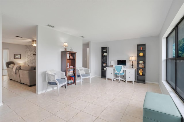 interior space featuring light tile patterned floors and ceiling fan