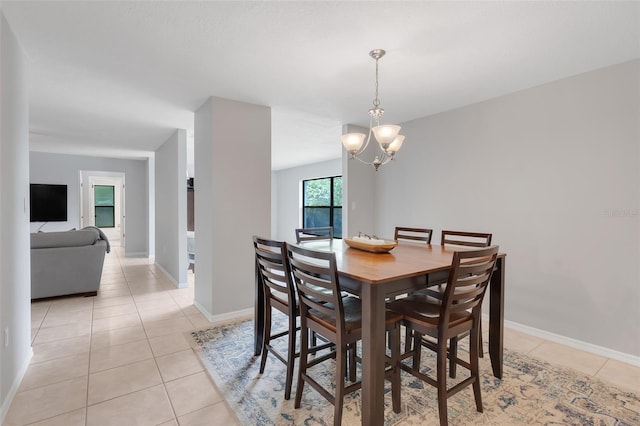 tiled dining space with a chandelier