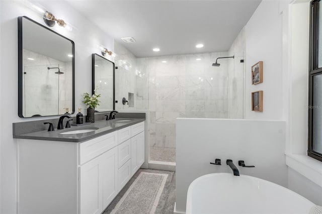 bathroom with vanity and shower with separate bathtub