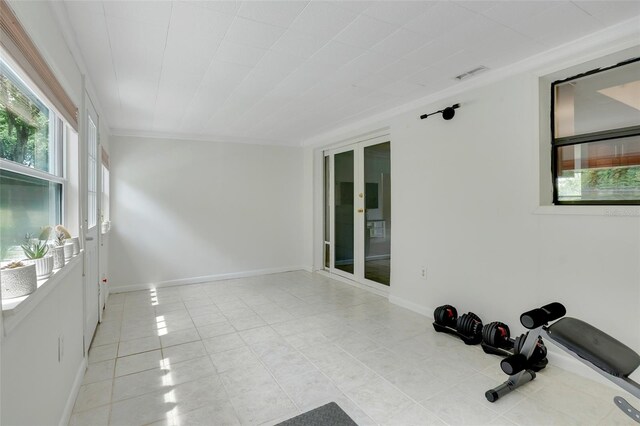 interior space featuring ornamental molding and light tile patterned flooring