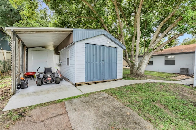 view of outbuilding featuring a yard and central air condition unit