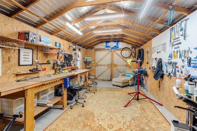 interior space with vaulted ceiling and a workshop area