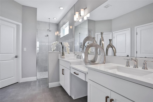 bathroom with tiled shower and vanity