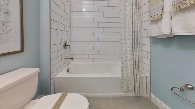 bathroom with toilet, shower / tub combo, and tile patterned floors