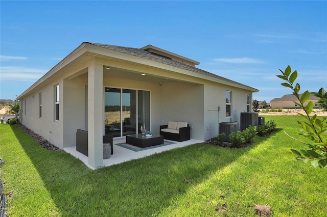 back of property with central AC unit, a yard, outdoor lounge area, and a patio