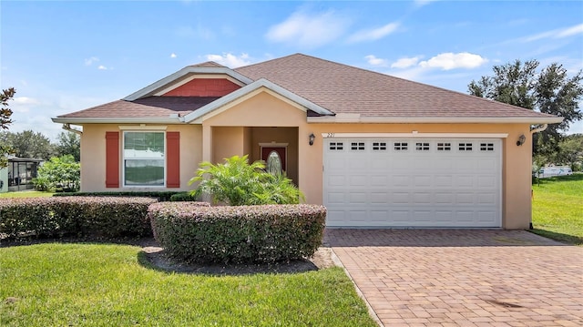 view of front of house with a front yard and a garage