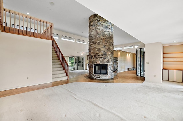 unfurnished living room with a fireplace and ceiling fan