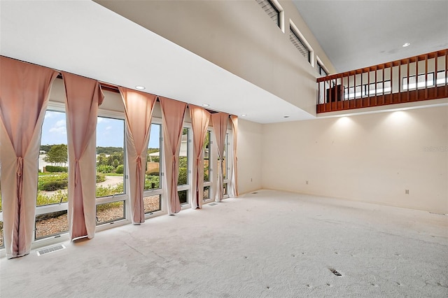 unfurnished living room featuring light carpet