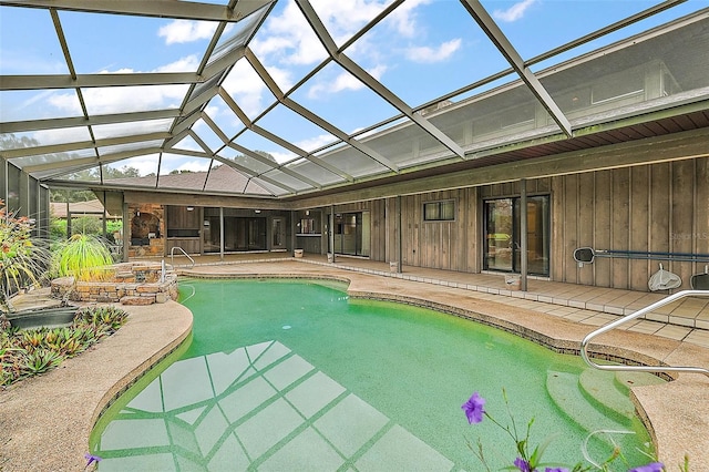 view of swimming pool with a lanai and a patio area