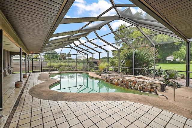 view of pool with a patio and glass enclosure