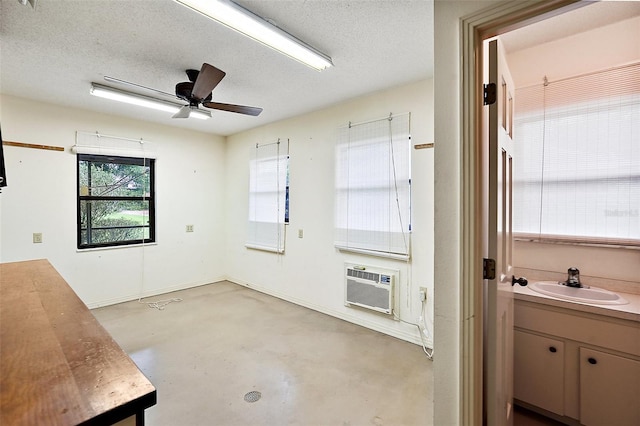 interior space featuring a textured ceiling, sink, and ceiling fan