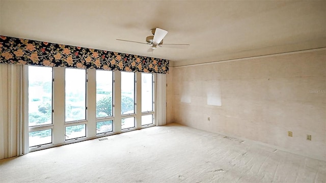 unfurnished room with ceiling fan