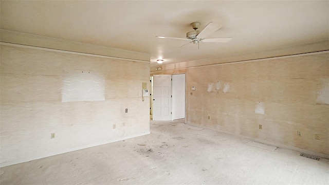 spare room with ceiling fan and concrete flooring