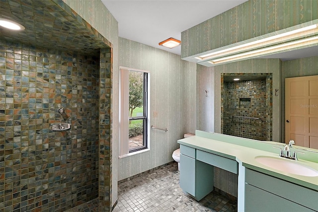 bathroom with tile patterned flooring, walk in shower, vanity, and toilet