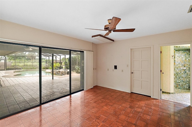 unfurnished room featuring ceiling fan and dark parquet floors