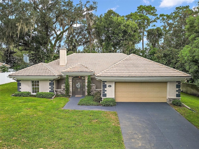 ranch-style house featuring a garage and a front yard