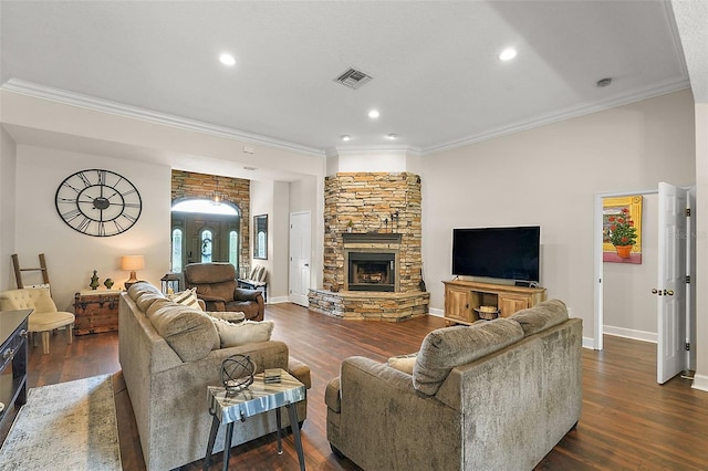 living room featuring dark hardwood / wood-style floors, ornamental molding, and a stone fireplace