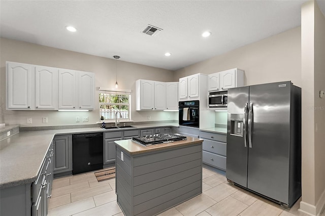 kitchen with gray cabinetry, black appliances, a center island, sink, and white cabinets