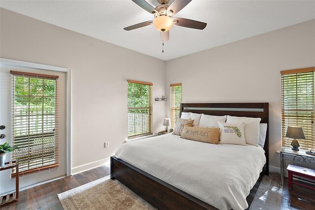 bedroom featuring dark wood-type flooring, ceiling fan, and access to exterior