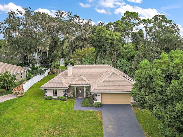 view of front of property featuring a garage and a front yard