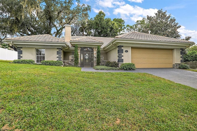 ranch-style home with a front yard and a garage